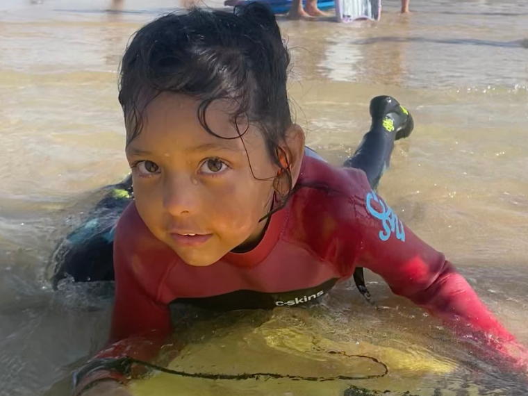 Saniyah on a body board in the sea